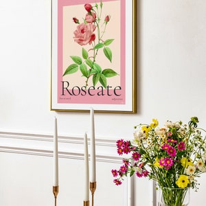 aesthetic dining room with candle sticks and fresh flowers. On the wall is a vintage floral art print featuring a watercolour hand painted rose