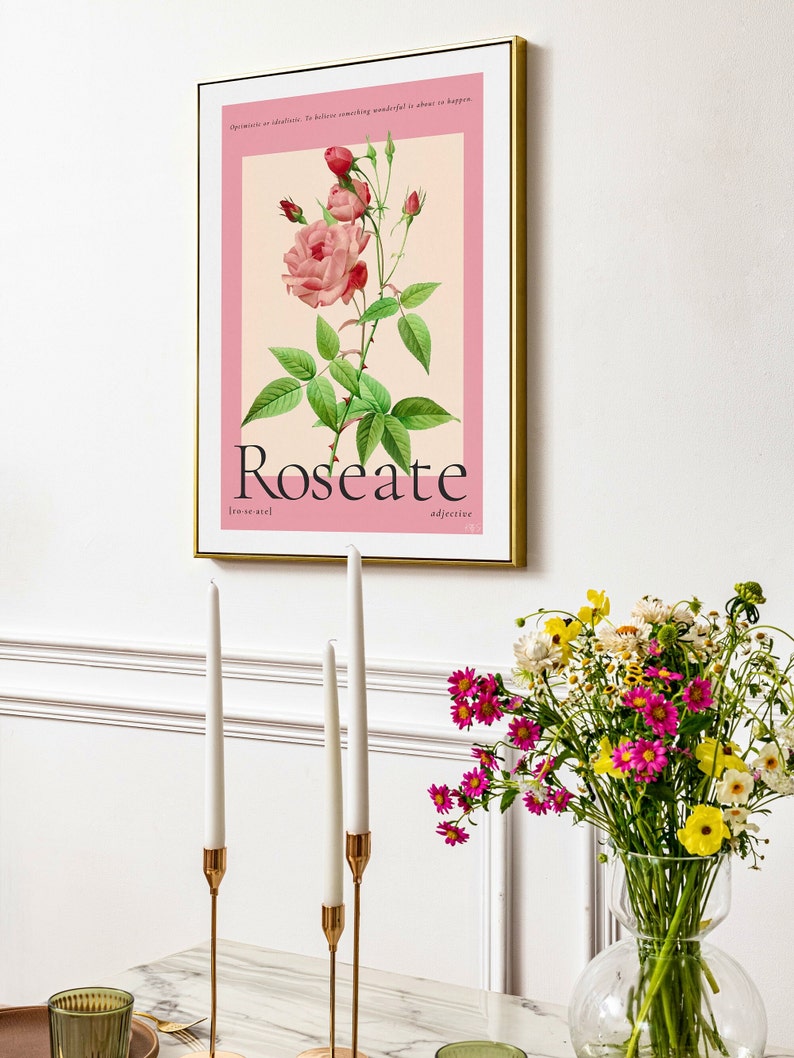 aesthetic dining room with candle sticks and fresh flowers. On the wall is a vintage floral art print featuring a watercolour hand painted rose