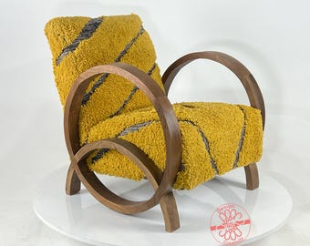 May include: A yellow and gray armchair with a unique curved wooden frame. The chair is upholstered in a soft, fuzzy fabric with a striped pattern.