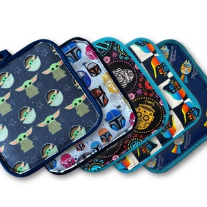 May include: A collection of five square pot holders with various Star Wars-themed patterns. Designs include Baby Yoda, Boba Fett, and other characters. Each pot holder has a dark blue border and a loop for hanging.