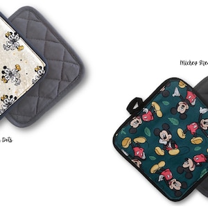 May include: Two square pot holders with a quilted back. One pot holder features a white background with yellow polka dots and a repeated pattern of Mickey Mouse. The other pot holder features a green background with a repeated pattern of Mickey Mouse and green leaves. The text "Yellow Polka Dots" is below the first pot holder and the text "Mickey Green" is below the second pot holder.