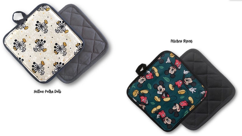 May include: Two square pot holders with a quilted back. One pot holder features a white background with yellow polka dots and a repeated pattern of Mickey Mouse. The other pot holder features a green background with a repeated pattern of Mickey Mouse and green leaves. The text "Yellow Polka Dots" is below the first pot holder and the text "Mickey Green" is below the second pot holder.