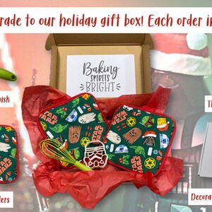May include: Holiday gift box with Star Wars themed items. Includes a green whisk, two green pot holders, a cookie cutter, and a decorated gift box. The pot holders have Star Wars characters on them. The box has the text "Baking Spirits Bright".