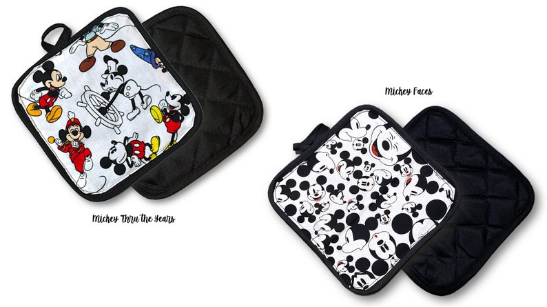 May include: Two black and white quilted pot holders with a Mickey Mouse theme. One pot holder features Mickey Mouse through the years and the other features Mickey Mouse faces.  The text "Mickey Faces" and "Mickey Thru the Years" is printed below each pot holder.