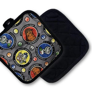 May include: Two square pot holders. One features a gray background with Star Wars character medallions and the text "1st Resistance Crew" and "Rebels". The other is solid black with a quilted pattern.