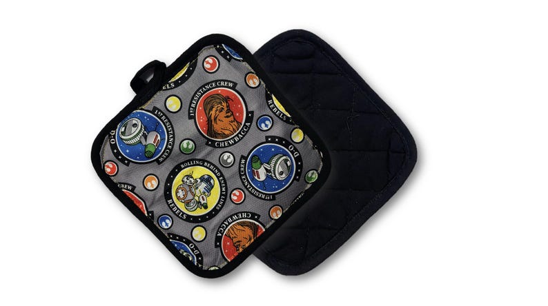 May include: Two square pot holders. One features a gray background with Star Wars character medallions and the text "1st Resistance Crew" and "Rebels". The other is solid black with a quilted pattern.
