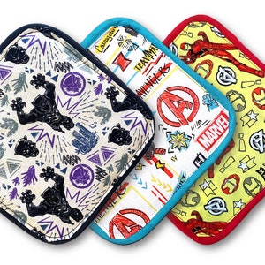 May include: Set of three Marvel-themed oven mitts. The mitts are square shaped with a black, blue, and red trim. The black mitt features a black panther design, the blue mitt features the Avengers logo, and the red mitt features Iron Man.