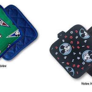 May include: Two sets of pot holders. The first set has a green background with a blue border and a pattern of Mickey Mouse in red, white, and blue. The second set has a black background with a blue border and a pattern of Mickey Mouse in red, white, and blue. The text "Retro Mickey" is below the first set and "Mickey Setters" is below the second set.