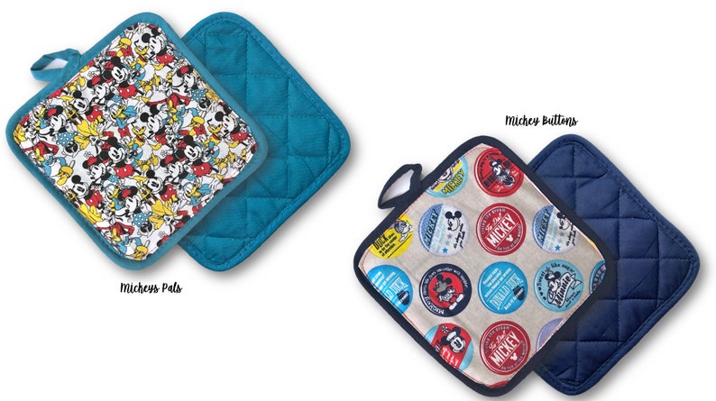 May include: Two quilted pot holders with a Mickey Mouse theme. One pot holder features a blue background with a white and yellow pattern of Mickey Mouse and his friends. The other pot holder features a beige background with a red, blue, and yellow pattern of Mickey Mouse buttons. Both pot holders have a dark blue quilted back.