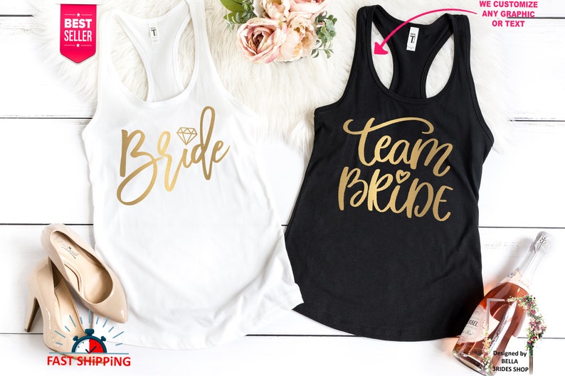 May include: Two white tank tops with gold lettering. One says "Bride" with a diamond graphic. The other says "Team Bride" with a heart graphic.