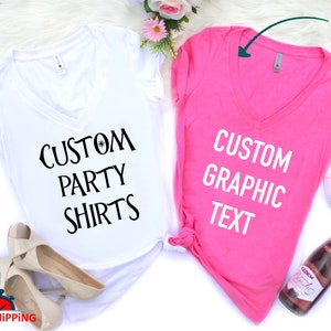 May include: Two V-neck t-shirts, one white and one pink, with the text "CUSTOM PARTY SHIRTS" on the white shirt and "CUSTOM GRAPHIC TEXT" on the pink shirt.