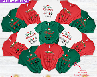 May include: A set of ten green, red, and white t-shirts with a Christmas theme. Each shirt features a different family member title, such as "mommy", "baby", "grandma", "daddy", "brother", "sister", "cousin", "uncle", "aunt", and "grandpa". The shirts have a festive design with ornaments and a Santa hat.