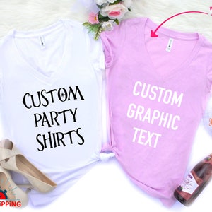 May include: Two V-neck t-shirts, one white and one pink, with the text "CUSTOM PARTY SHIRTS" on the white shirt and "CUSTOM GRAPHIC TEXT" on the pink shirt.