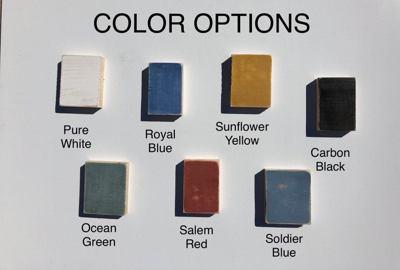May include: Color options for a product, shown as painted wood squares. The colors are: Pure White, Royal Blue, Sunflower Yellow, Carbon Black, Ocean Green, Salem Red, and Soldier Blue.