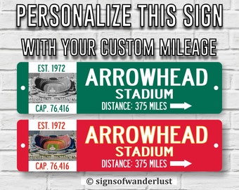 May include: Two personalized signs with a green and red background. The signs feature a picture of Arrowhead Stadium, the text "Arrowhead Stadium", and the text "Distance: 375 miles". The signs also include the text "Est. 1972" and "Cap. 76,416".