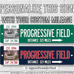 May include: Two personalized signs with a baseball stadium image, text that reads "EST. 1994", "CAP. 34,788", "PROGRESSIVE FIELD", and "DISTANCE: 321 MILES", and an arrow pointing to the right. The top sign is green and the bottom sign is blue.