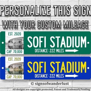 May include: Two personalized metal signs with a blue and green background. The signs feature a picture of SoFi Stadium, the text "SOFI STADIUM", and the text "EST. 2020 CAP. 70,000". The signs also include the text "DISTANCE: 222 MILES" and an arrow pointing to the right.