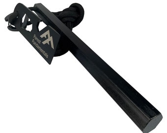 May include: Black fire starter with a black cord and a metal striker with the text "Forest Fundamentals" and a mountain logo.