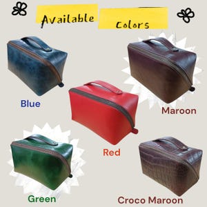 May include: A selection of rectangular zippered bags in blue, maroon, red, green, and crocodile-textured maroon. Each bag features a top handle and a wraparound zip. The words "Available Colors" are displayed.