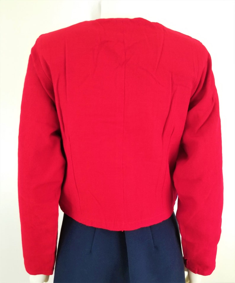 May include: A red cropped jacket with long sleeves.