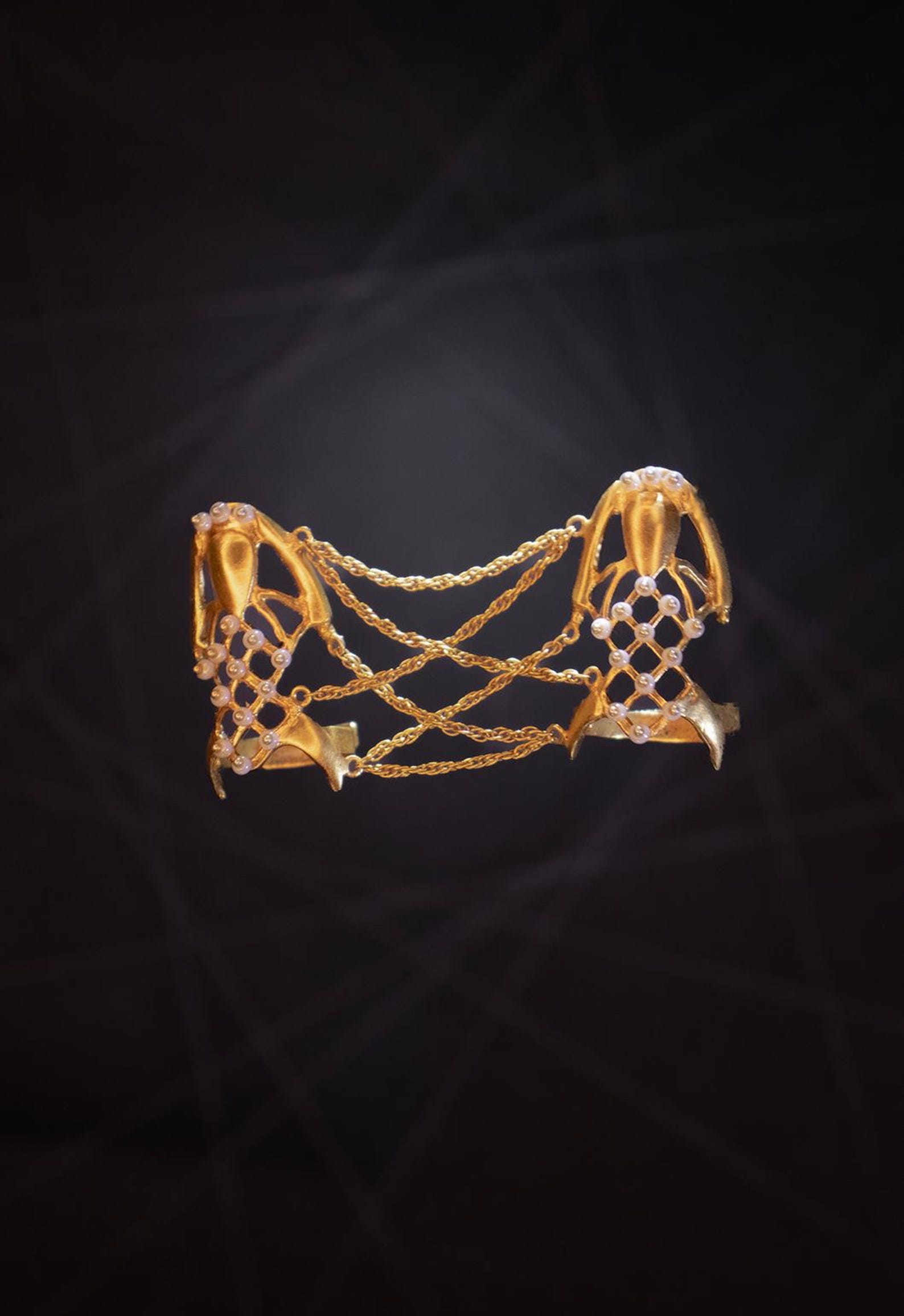 Gold-plated version of spiderweb finger ring with pearl accents and crisscrossing chains