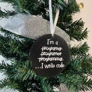 May include: Black round Christmas bauble with white text that reads "I'm a programmer... I write code".
