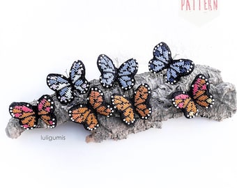 May include: A collection of handmade butterfly ornaments in various colors, including orange, pink, and blue, are displayed on a piece of textured wood. The butterflies have intricate patterns and are arranged in a row. The word "PATTERN" is visible in the image.