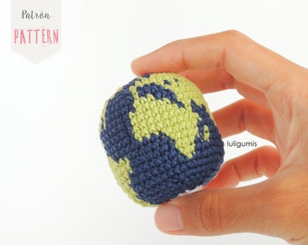 May include: A crocheted globe with a blue and green color scheme. The globe is being held in a hand.