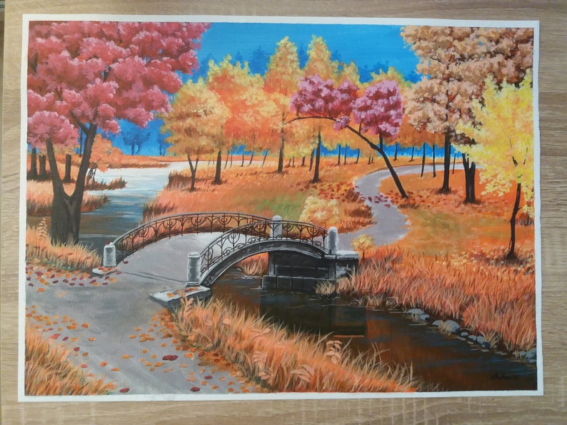 May include: A painting of a bridge over a stream in a park with fall foliage. The trees are a mix of red, yellow, and orange. The bridge is made of stone and has a metal railing. The stream is surrounded by tall grass.