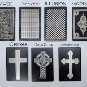 May include: A collection of black rectangular cards with various designs. The cards feature patterns like a maze, diamond grid, checkered illusion, and ornate designs. Other cards display crosses, including a Celtic and Orthodox cross. The cards have text labels.