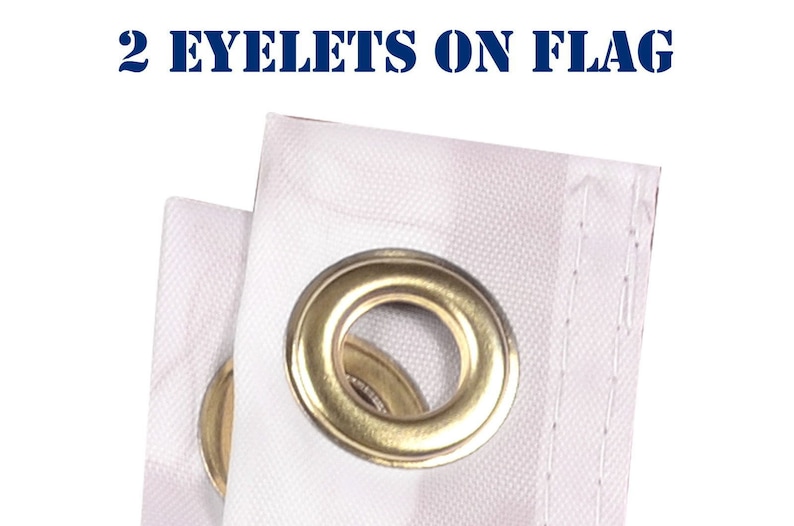 May include: Close-up of two brass eyelets on a white fabric flag. The eyelets are used for hanging the flag.