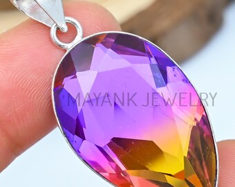 May include: A teardrop-shaped pendant with a purple, pink, and yellow iridescent gemstone set in silver.