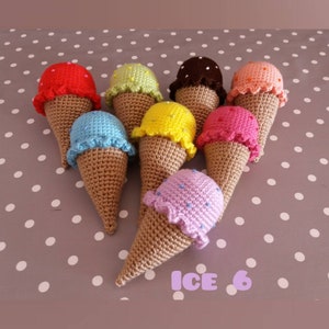May include: A collection of eight crocheted ice cream cones in various colors, including red, green, brown, orange, blue, yellow, pink, and purple. Each cone has a different colored ice cream scoop with white sprinkles. The cones are arranged in a circle on a gray background with white polka dots. The text "ICE 6" is written in purple letters at the bottom of the image.