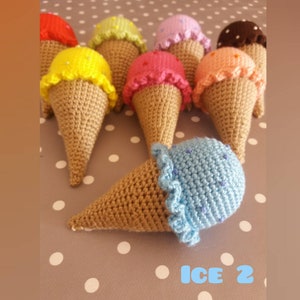 May include: A collection of crocheted ice cream cones in various colors, including yellow, pink, blue, green, purple, and brown. The cones are all made with brown yarn and have a white polka dot background.