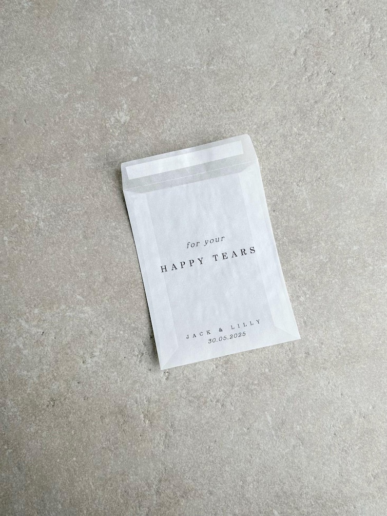 May include: White envelope with the text "for your HAPPY TEARS" and "JACK & LILLY 30.05.2025" printed on it.