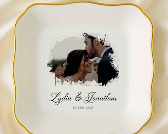 May include: White ceramic trinket dish with a gold rim and a photo of a couple kissing. The dish is square with wavy edges and features the names "Lydia & Jonathan" and the date "11 SEP, 2025".