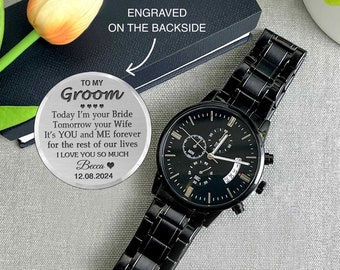 May include: A black wristwatch with a silver engraved message on a round metal disc. The message reads "To my Groom Today I'm your Bride Tomorrow your Wife It's YOU and ME forever for the rest of our lives I LOVE YOU SO MUCH Becca 12.08.2024".