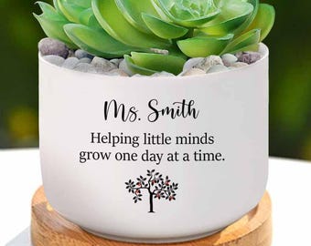 May include: White ceramic planter with a succulent plant and the text "Ms. Smith Helping little minds grow one day at a time." with a small tree graphic.