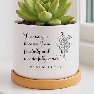 May include: White ceramic planter with a succulent plant and the text "I praise you because I am fearfully and wonderfully made." PSALM 139:14