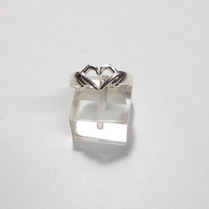 heart ring with hands in silver