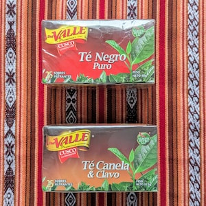 May include: Two boxes of Valle tea bags. The top box is labeled "T&eacute; Negro Puro" and the bottom box is labeled "T&eacute; Canela & Clavo". Both boxes are red and white with a green leaf design.