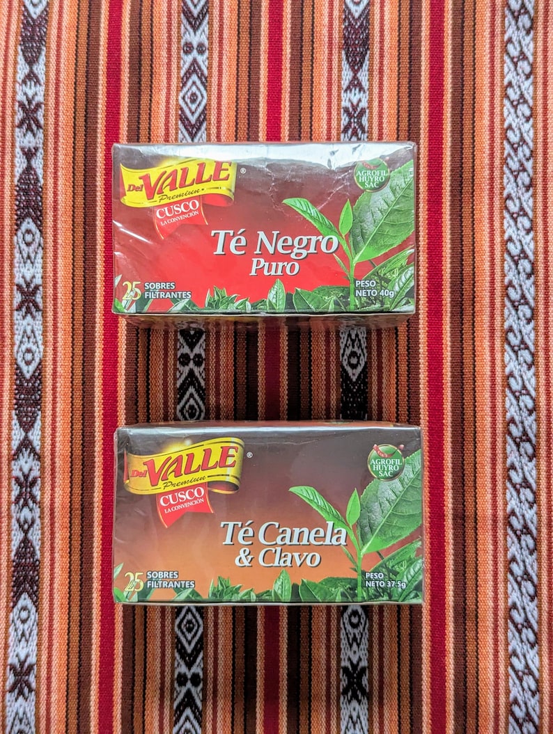 May include: Two boxes of Valle tea bags. The top box is labeled "T&eacute; Negro Puro" and the bottom box is labeled "T&eacute; Canela & Clavo". Both boxes are red and white with a green leaf design.