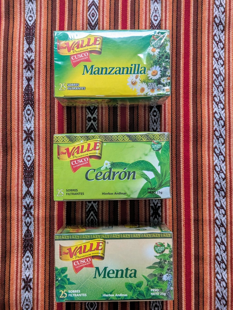 May include: Three boxes of Valle Cusco tea bags. The boxes are green and yellow with a gold border. The tea flavors are Manzanilla, Cedr&oacute;n, and Menta. Each box has a picture of the herb on the front.