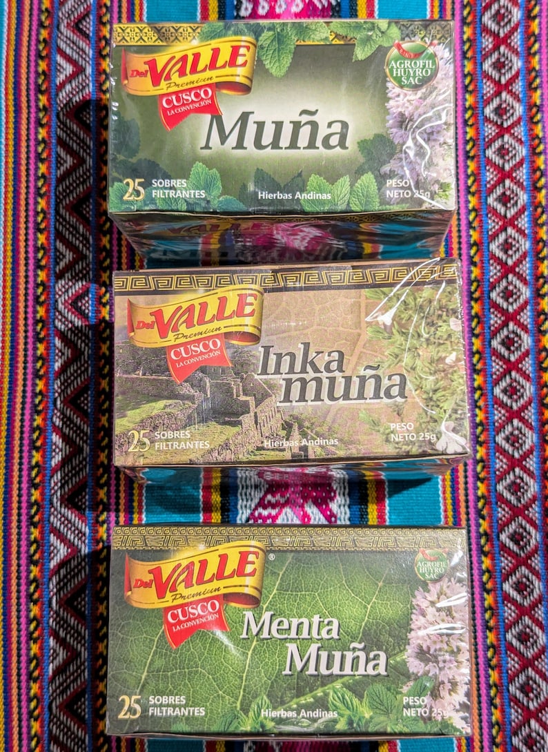 May include: Three boxes of herbal tea bags, each with a different flavor: Mu&ntilde;a, Inka Mu&ntilde;a, and Menta Mu&ntilde;a. The boxes are all green and white with the brand name "Del Valle" and the text "Cusco La Convencion" printed on them. Each box contains 25 tea bags and weighs 250 grams.