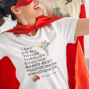 May include: A woman and a girl wearing red superhero capes and masks. The woman is holding the girl on her shoulders. The woman's shirt has the text "I can do all things through evidence-based best practice which strengthens me." and a colorful puzzle piece graphic.
