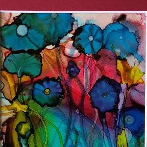 May include: Abstract painting of colorful flowers with blue, green, yellow, red, and purple hues. The flowers are painted in a loose, flowing style, creating a sense of movement and energy.