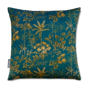 May include: Teal velvet cushion with a gold leaf and leopard print pattern. The cushion features a tropical jungle design with palm trees, leaves, and animal prints.