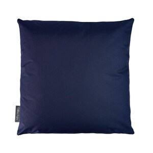 May include: A dark blue square pillow with a small white label that says "Cotta Design" in the bottom left corner.