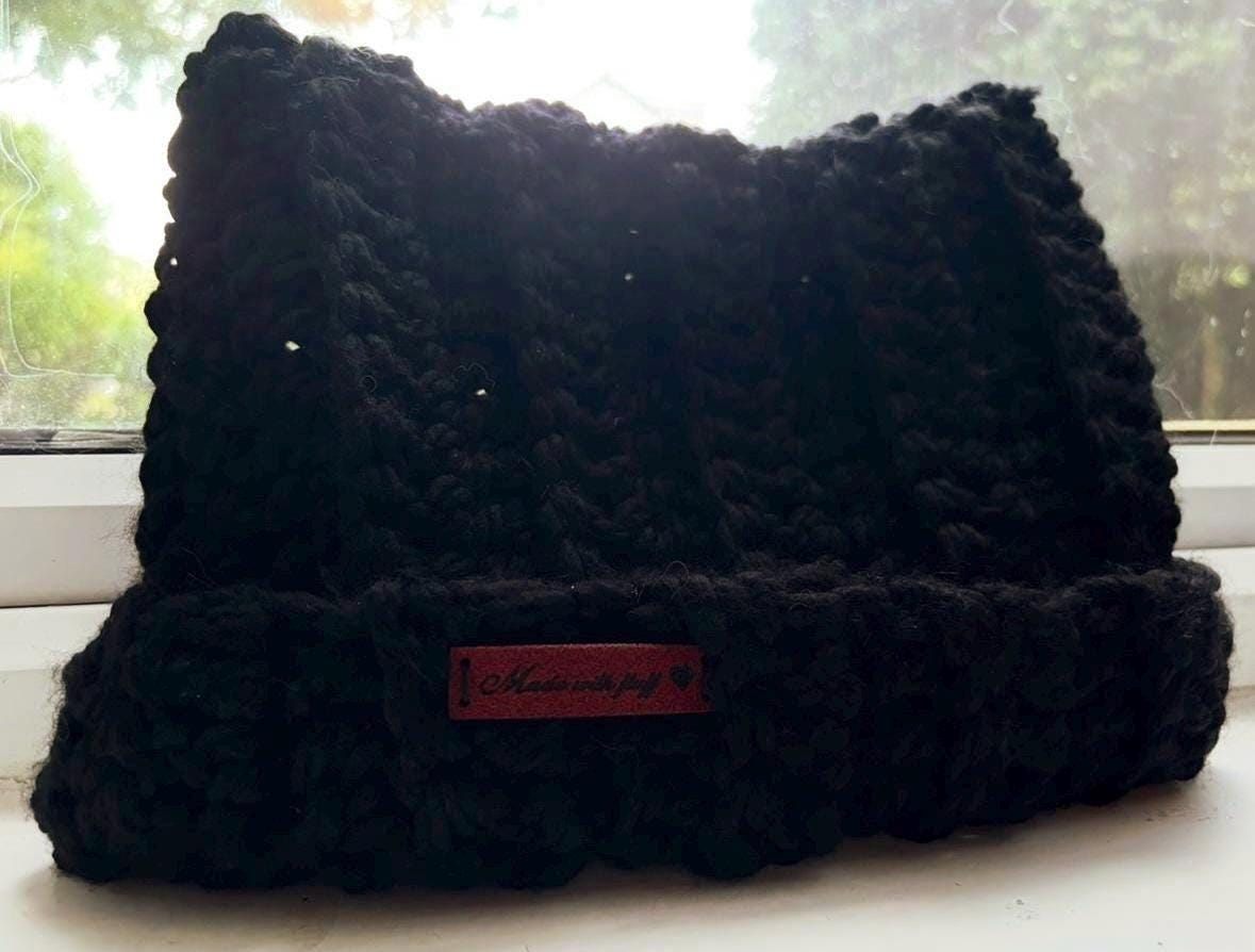 Black crochet cat hat with red label