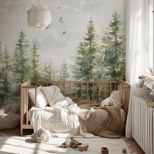 May include: A nursery scene featuring a wooden crib with bedding, a soft rug, and a forest-themed mural. The room is decorated with a paper lantern and wooden toys, creating a cozy and natural atmosphere.
